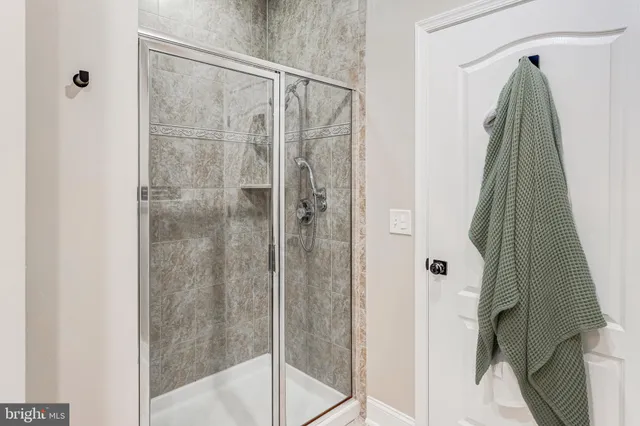 a bathroom with a shower and a glass door