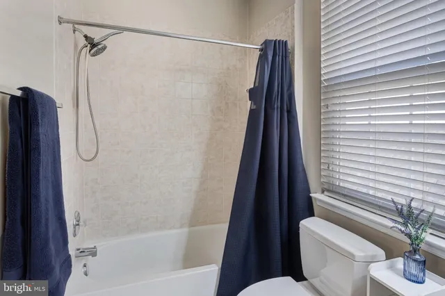 a bathroom with a shower a toilet and a sink