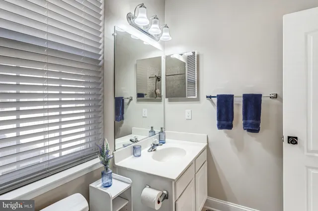 a bathroom with a sink vanity and a mirror