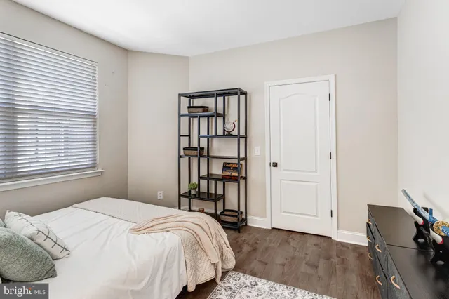 a bedroom with a bed and a book shelf