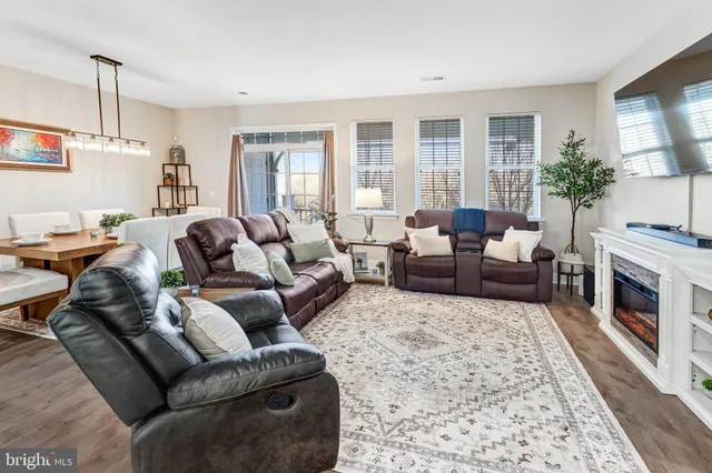 a living room with furniture fireplace and a window