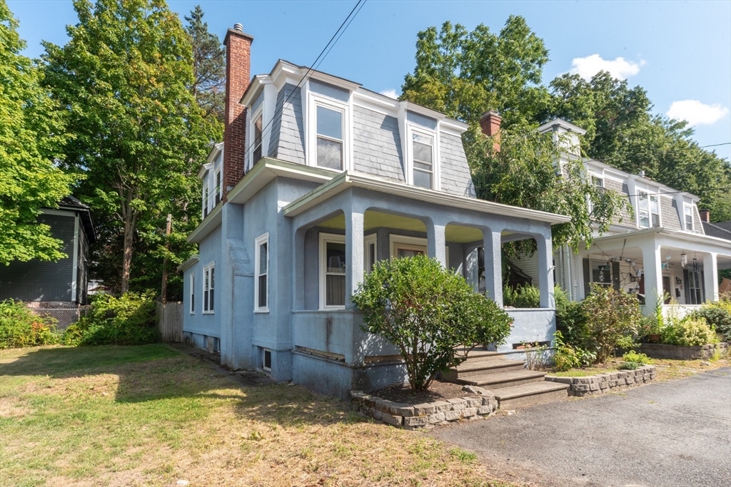 89 1/2 Walnut Street Clinton, MA 01510 - Photo 2 of 36 a front view of a house with garden