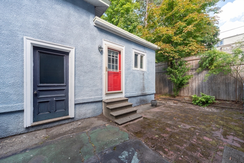 89 1/2 Walnut Street Clinton, MA 01510 - Photo 33 of 36 a backyard of a house with barbeque oven and trees