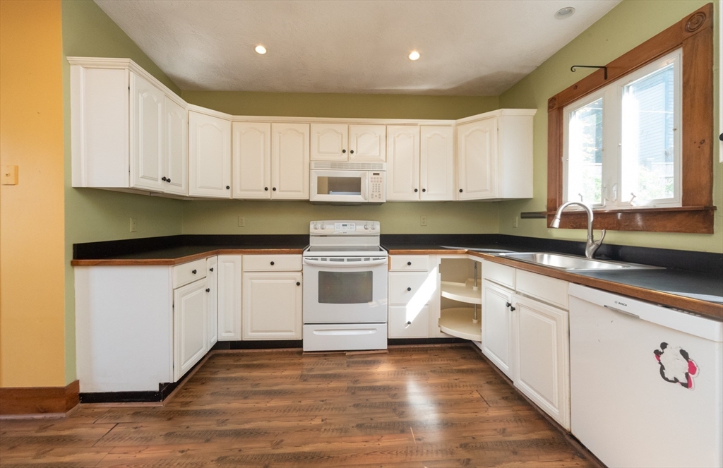 89 1/2 Walnut Street Clinton, MA 01510 - Photo 8 of 36 a kitchen with granite countertop white cabinets and white appliances
