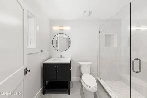 a bathroom with a toilet a sink and a shower