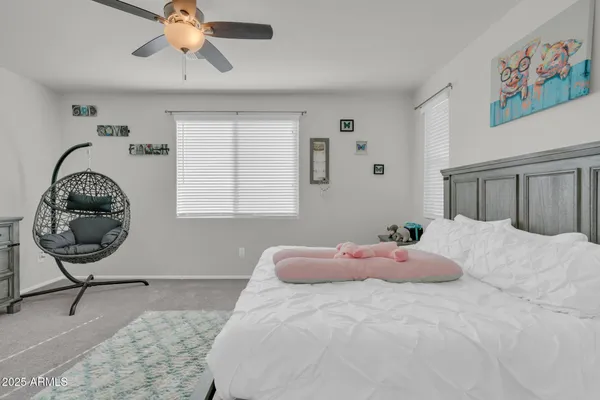 a living room with furniture a flat screen tv and kitchen view