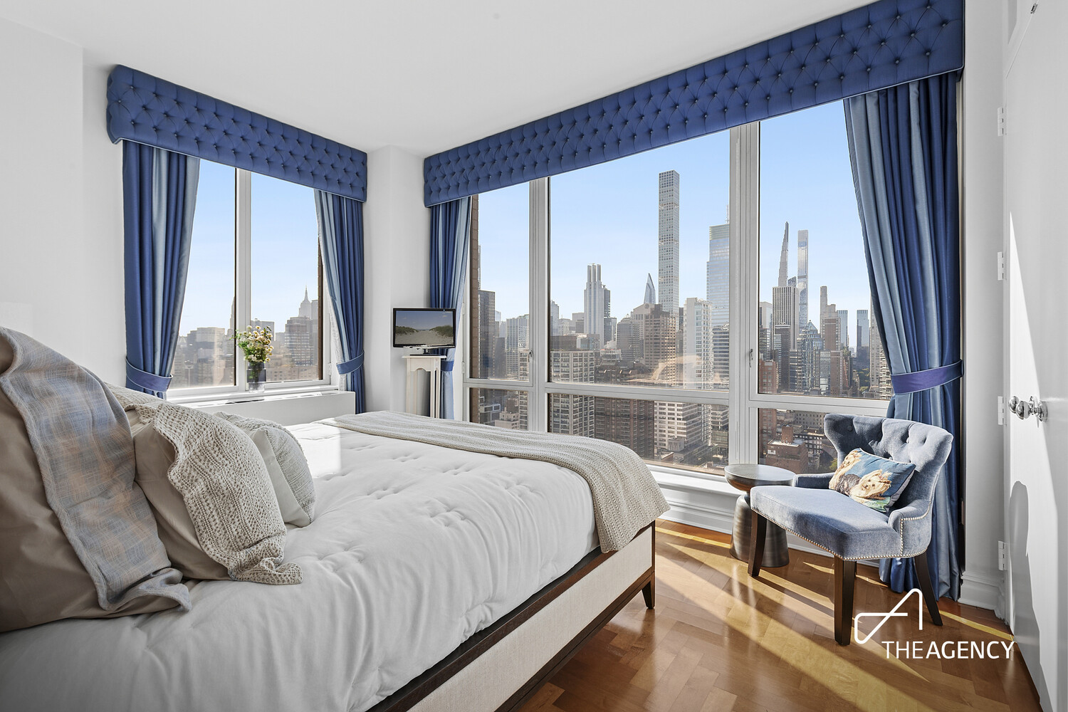 401 East 60th Street, Unit 35B Manhattan, NY 10022 - Photo 7 of 13 a bedroom with a bed and a large window with outer view