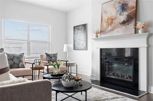 a kitchen with stainless steel appliances granite countertop a stove a sink a dining table and chairs