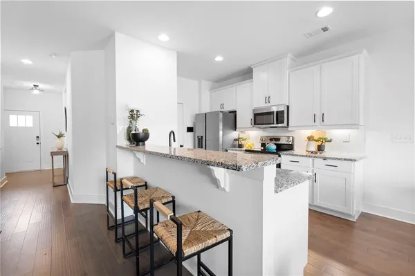 a living room with furniture a table and a potted plant