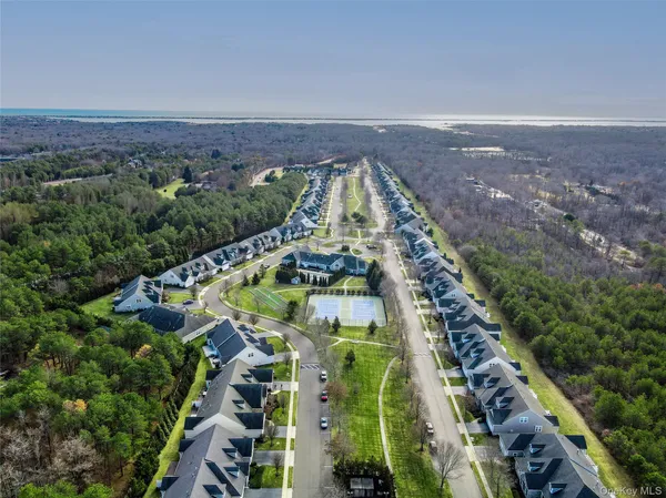 an aerial view of a house with a yard and lake view