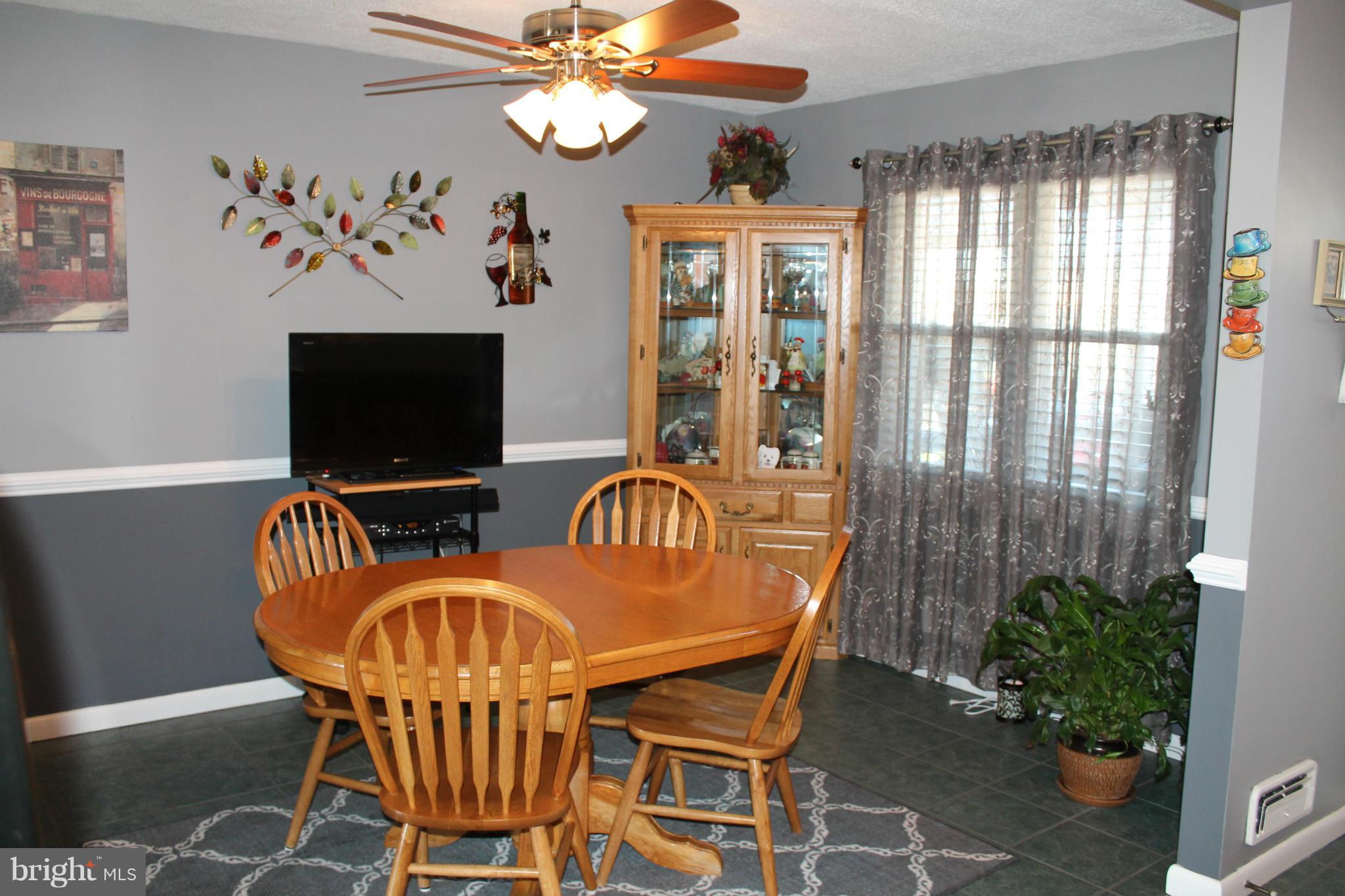 7702 Charlesmont Road Baltimore, MD 21222 - Photo 8 of 13 a view of a livingroom with furniture window and a chandelier