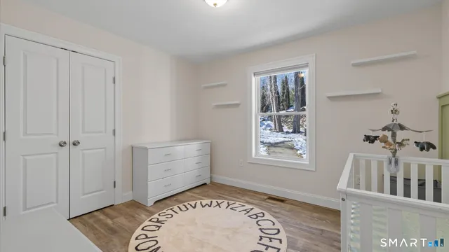 a view of a bedroom with wooden floor