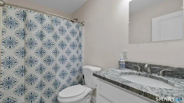 a bathroom with a toilet and a bathtub
