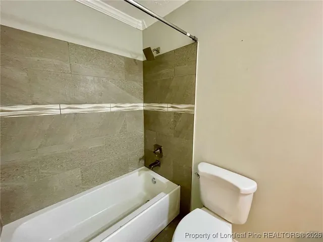 a spacious bathroom with a toilet sink and mirror