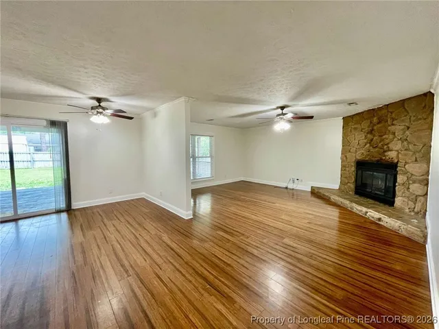 wooden floor in an empty room with a fireplace