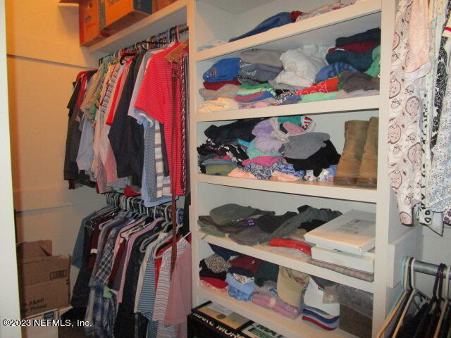 3704 Pete Johnson Road Macclenny, FL 32063 - Photo 13 of 18 a view of walk in closet with clothes and shoes