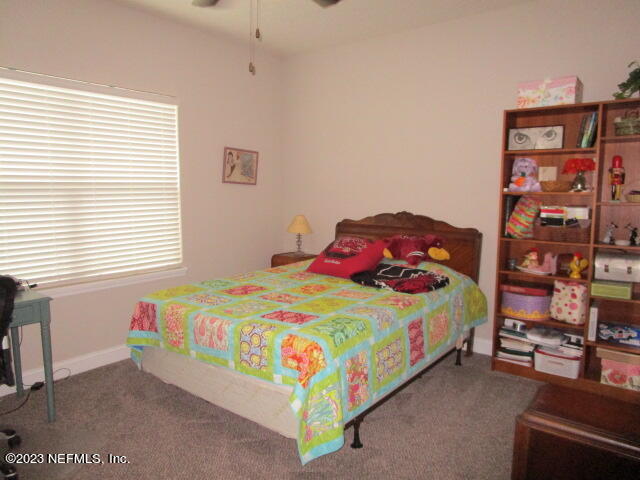 3704 Pete Johnson Road Macclenny, FL 32063 - Photo 14 of 18 a bedroom with a bed and a book shelf