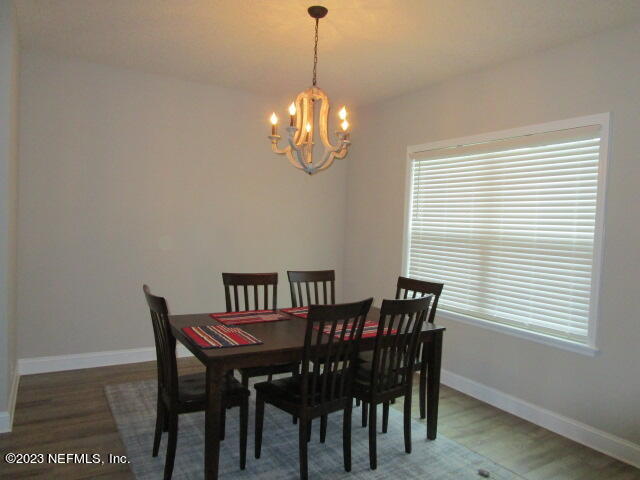 3704 Pete Johnson Road Macclenny, FL 32063 - Photo 3 of 18 a view of a dining room with furniture window and wooden floor