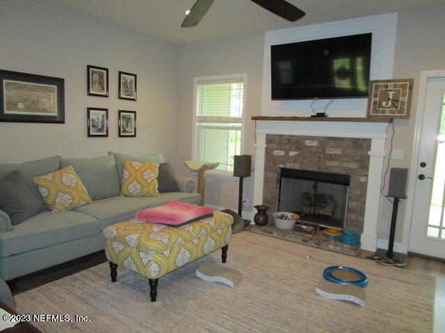 3704 Pete Johnson Road Macclenny, FL 32063 - Photo 5 of 18 a living room with furniture flat screen tv and a fireplace