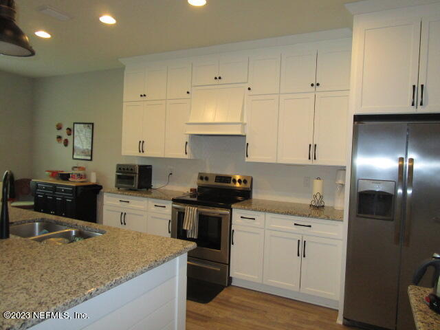 3704 Pete Johnson Road Macclenny, FL 32063 - Photo 6 of 18 a kitchen with cabinets and stainless steel appliances