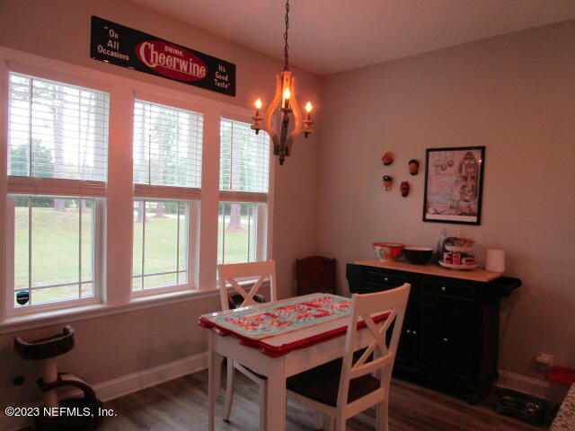3704 Pete Johnson Road Macclenny, FL 32063 - Photo 8 of 18 a view of a dining room with furniture window and wooden floor