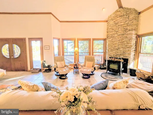 a dining room with furniture a chandelier and wooden floor
