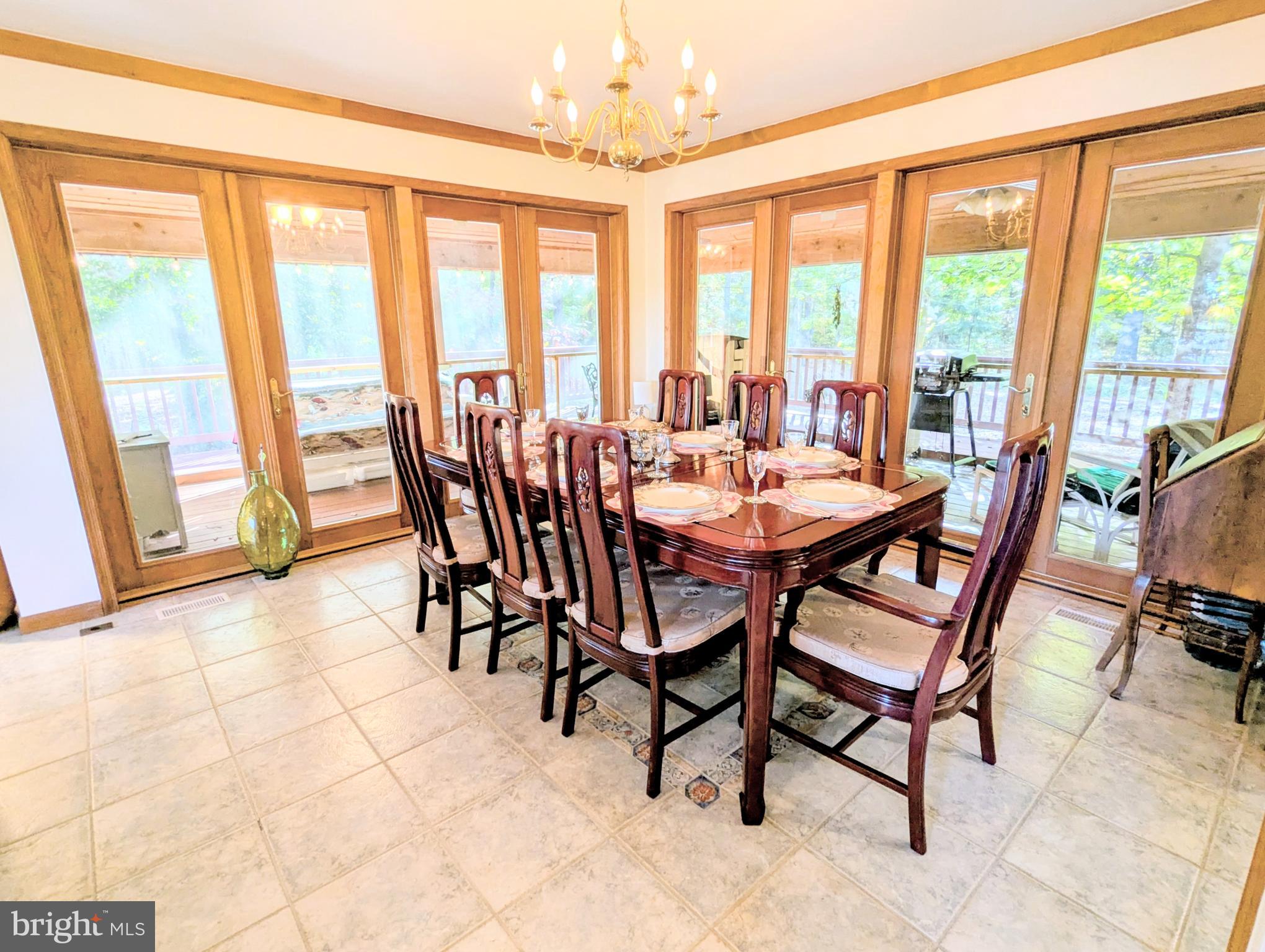 2006 Bennett Point Road Queenstown, MD 21658 - Photo 18 of 58 a dining room with furniture and large windows