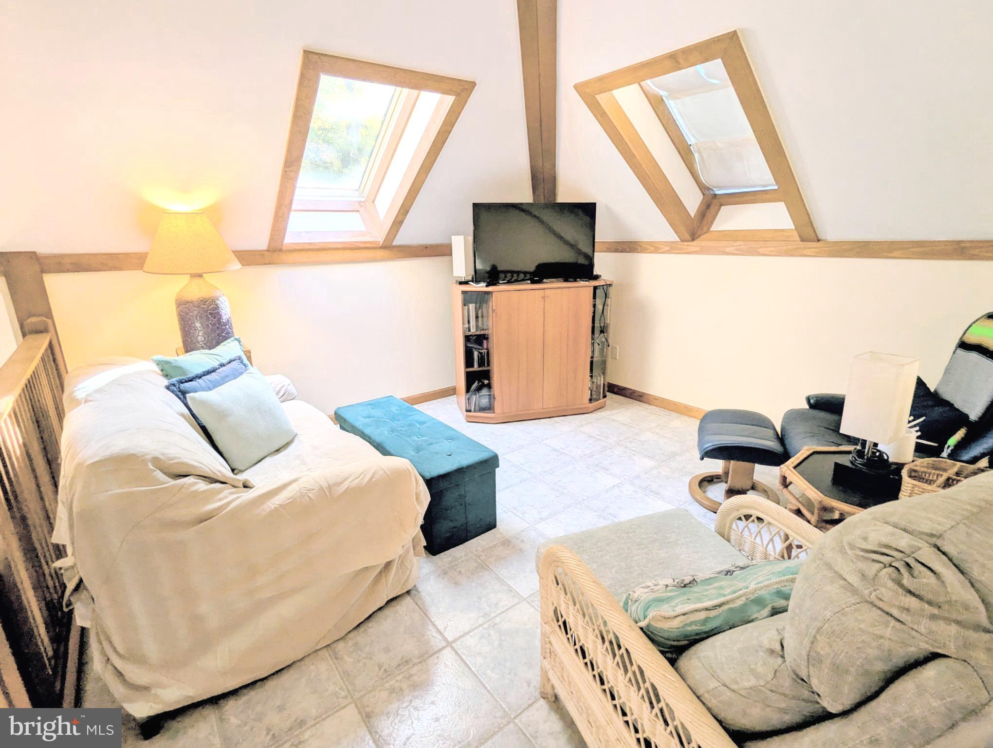 2006 Bennett Point Road Queenstown, MD 21658 - Photo 30 of 58 a living room with furniture and a flat screen tv