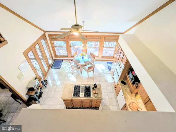 a bathroom with a granite countertop sink and a large mirror