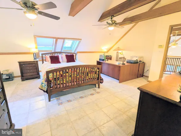 a bedroom with a bed a couch and a window