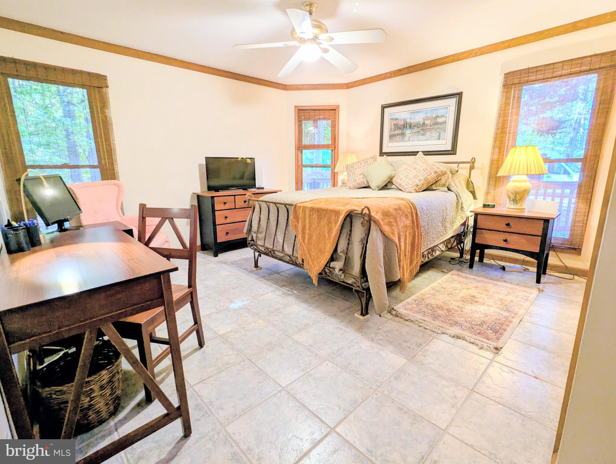 2006 Bennett Point Road Queenstown, MD 21658 - Photo 40 of 58 a bedroom with a bed a couch and a window