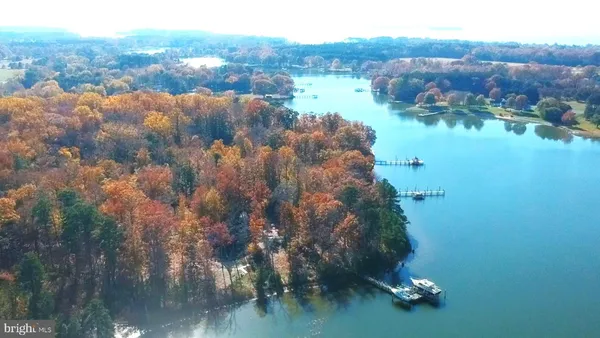 an aerial view of house with yard and lake view