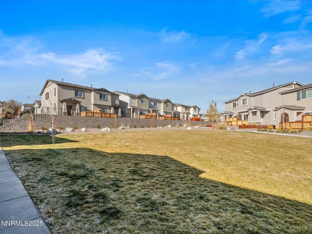 an aerial view of a house with a mountain