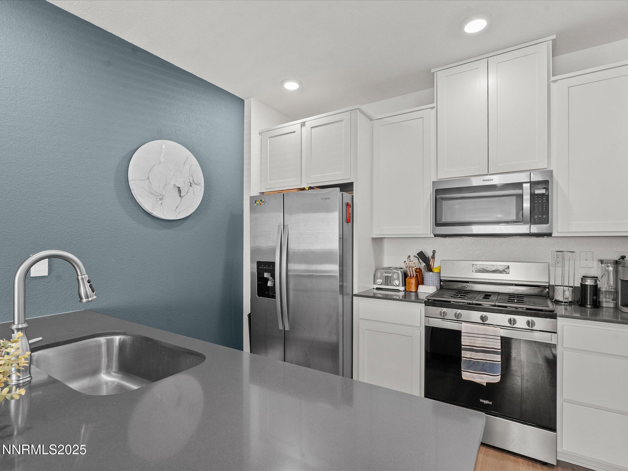 4232 Fawnridge Place Reno, NV 89523 - Photo 6 of 39 a kitchen with granite countertop a sink stainless steel appliances and cabinets