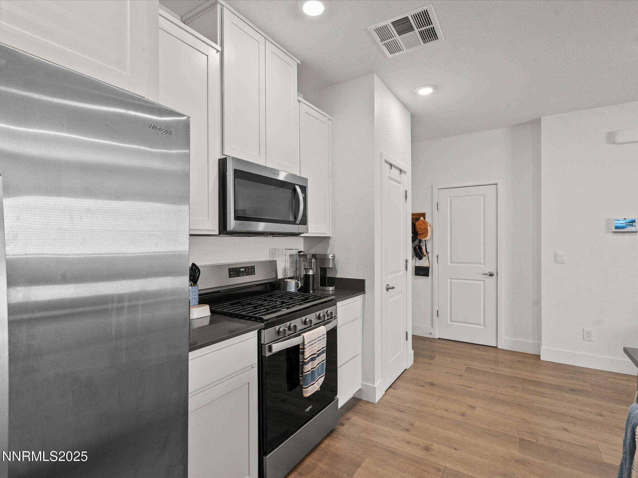 4232 Fawnridge Place Reno, NV 89523 - Photo 7 of 39 a kitchen with stainless steel appliances a stove microwave and a refrigerator