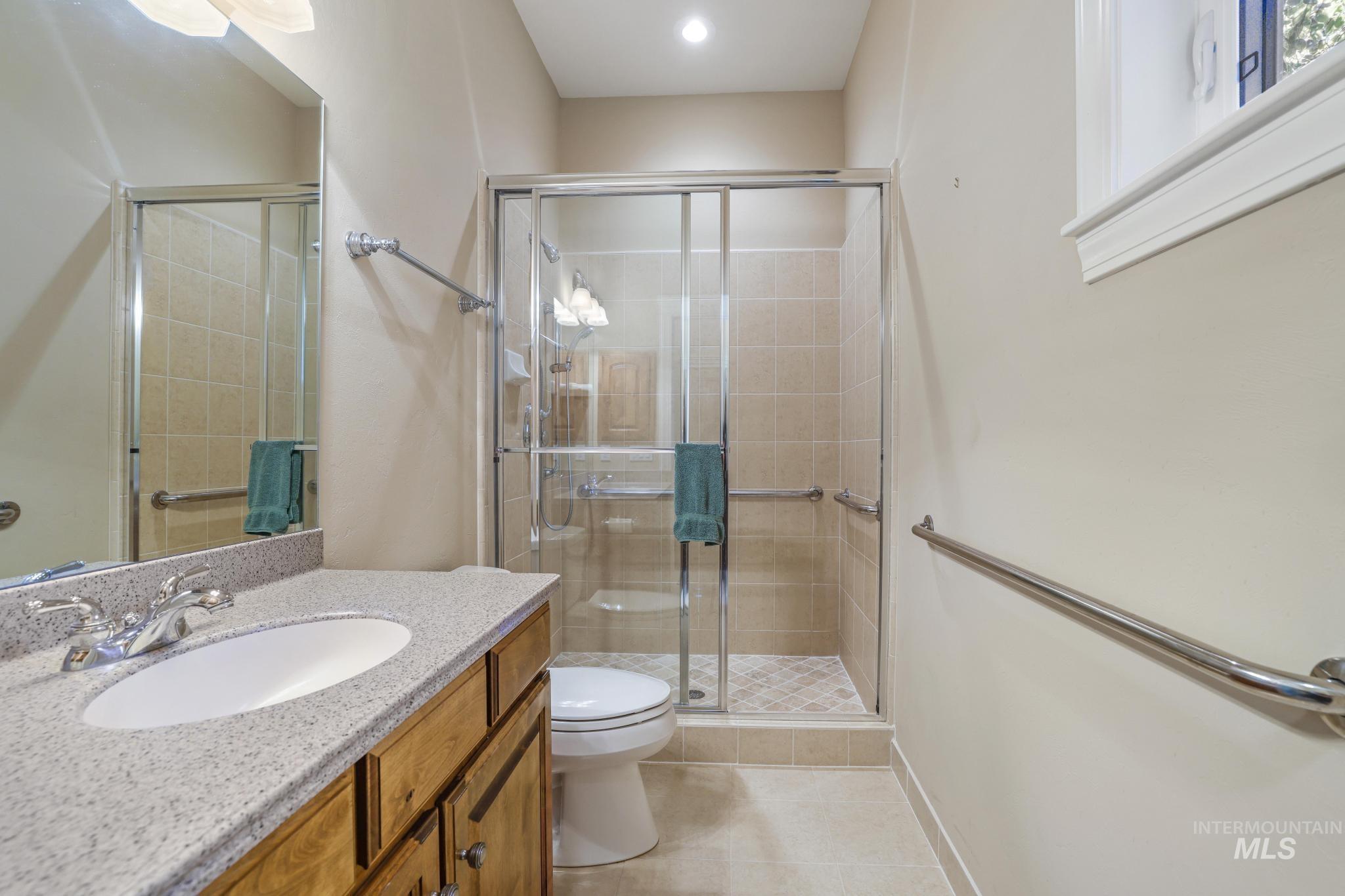 1526 Highway 26 Gooding, ID 83330 - Photo 11 of 48 Bathroom with vanity, a stall shower, and light tile patterned floors