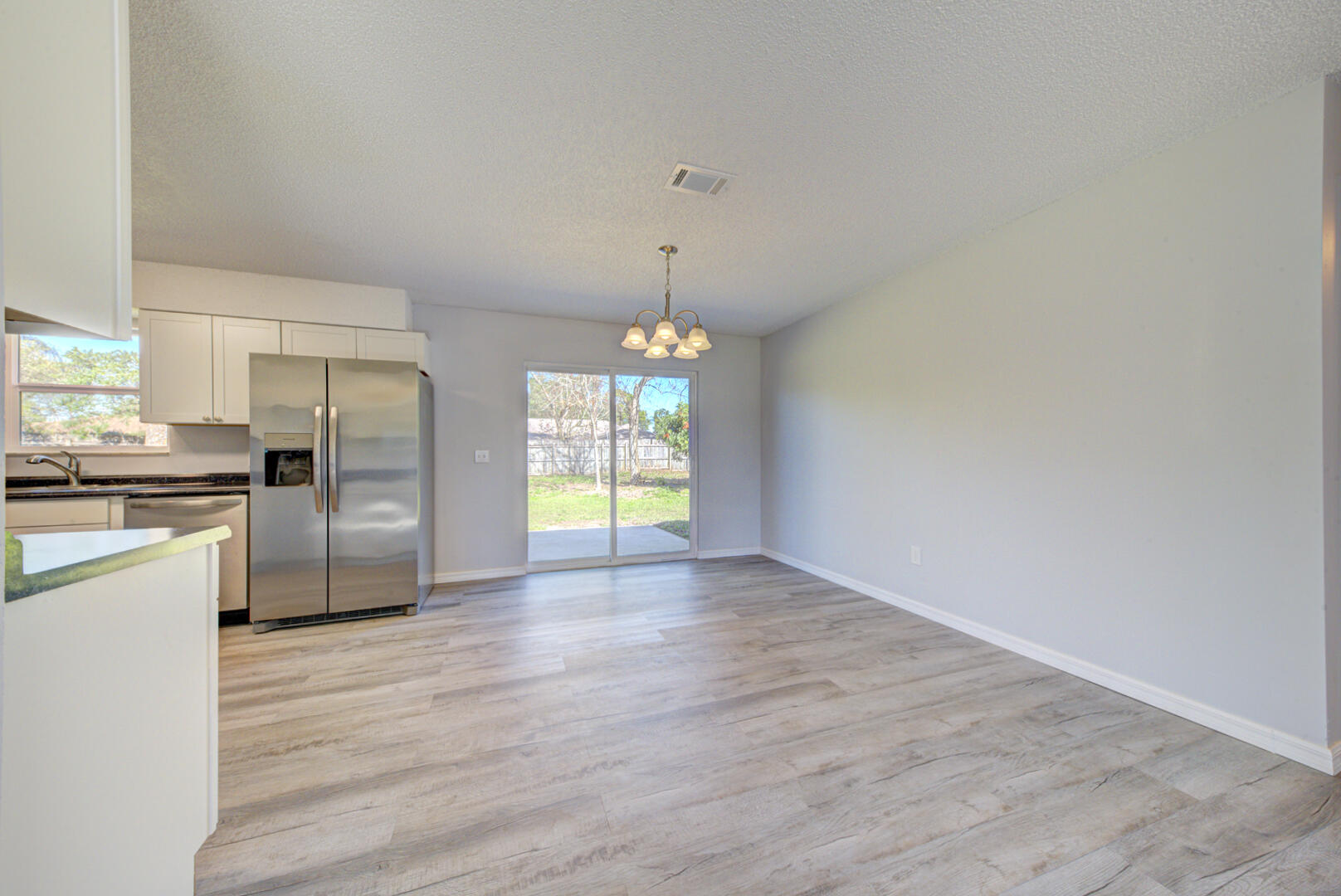 5356 Jamaica Road Cocoa, FL 32927 - Photo 12 of 41 a view of a kitchen with a sink a refrigerator and window