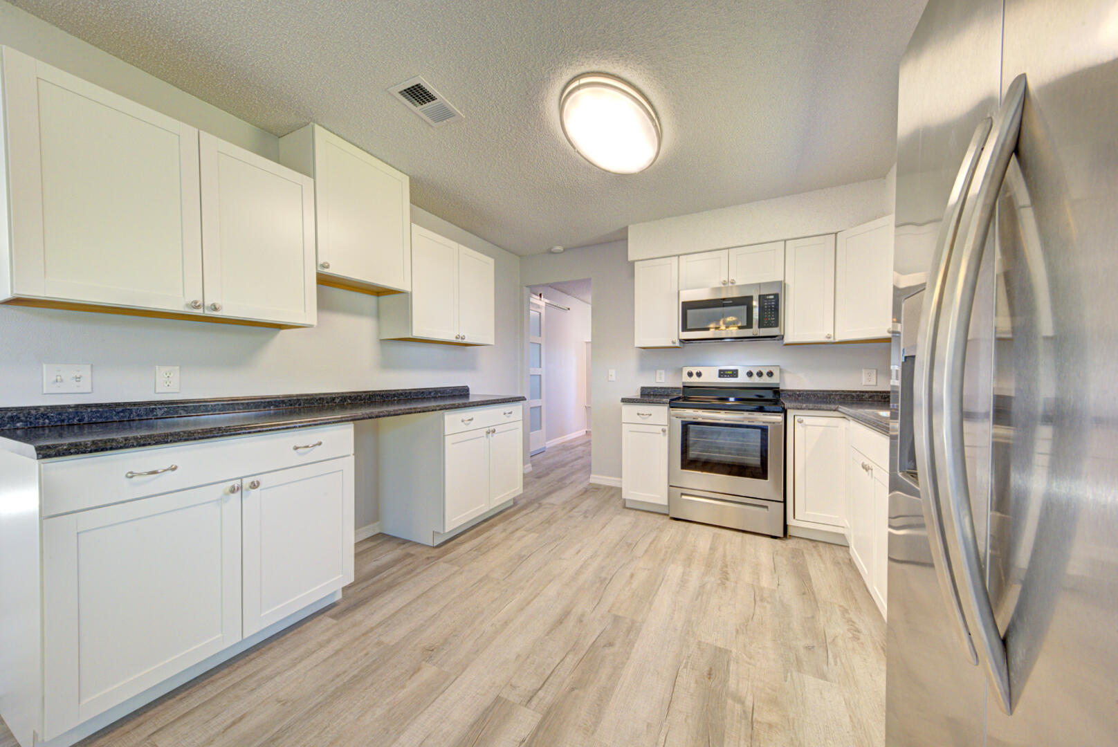 5356 Jamaica Road Cocoa, FL 32927 - Photo 15 of 41 a kitchen with stainless steel appliances granite countertop a stove a sink and a refrigerator