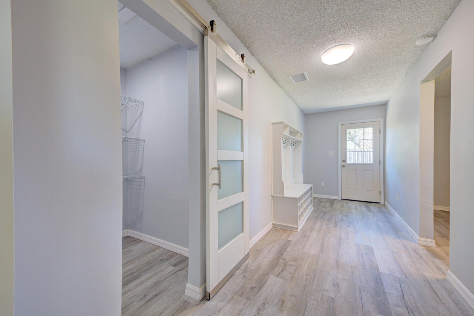 5356 Jamaica Road Cocoa, FL 32927 - Photo 18 of 41 wooden floor in an empty room with a window
