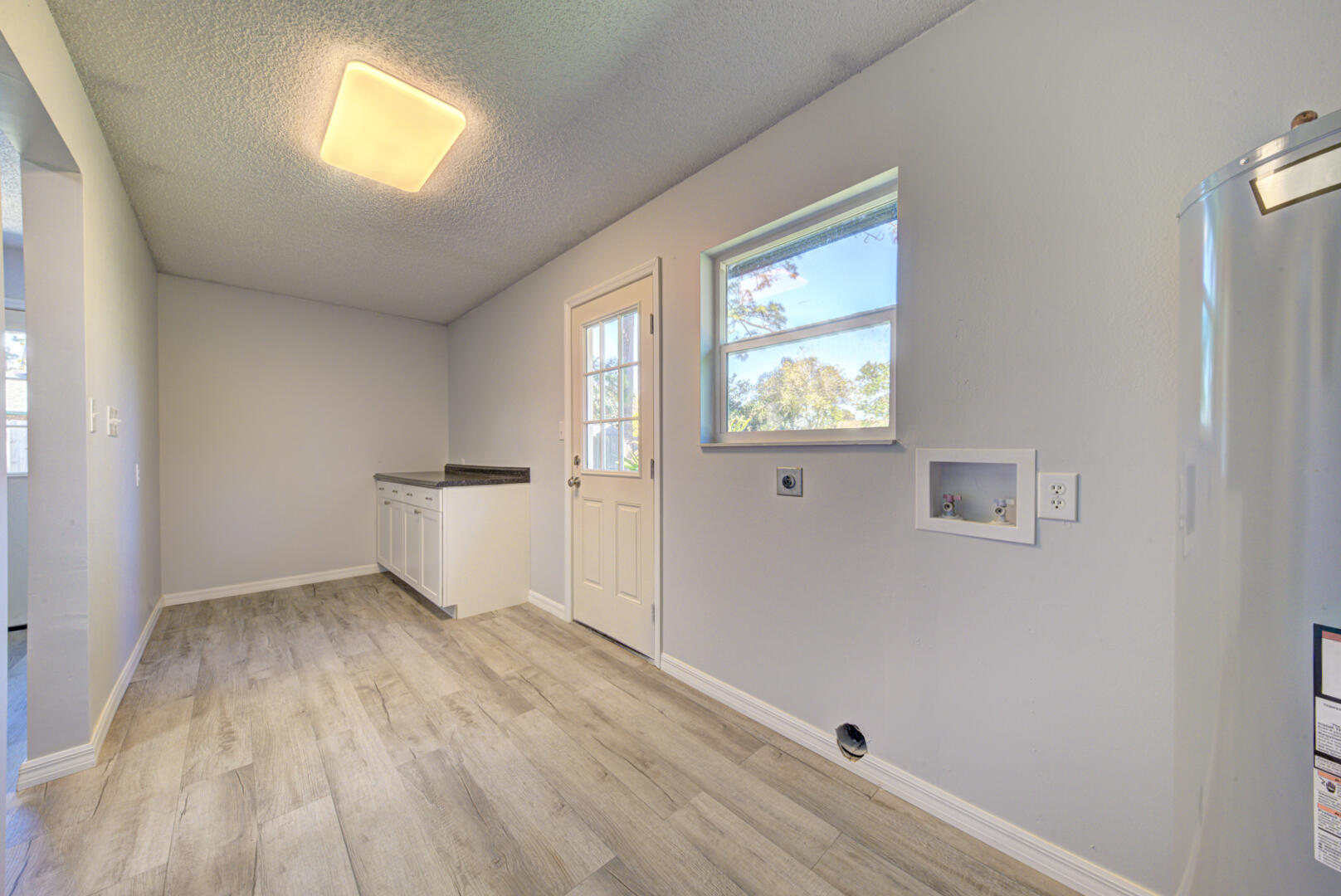 5356 Jamaica Road Cocoa, FL 32927 - Photo 19 of 41 wooden floor in an empty room with a window