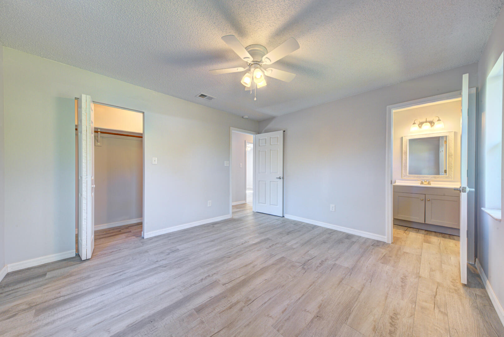 5356 Jamaica Road Cocoa, FL 32927 - Photo 22 of 41 a view of an empty room with wooden floor and a window
