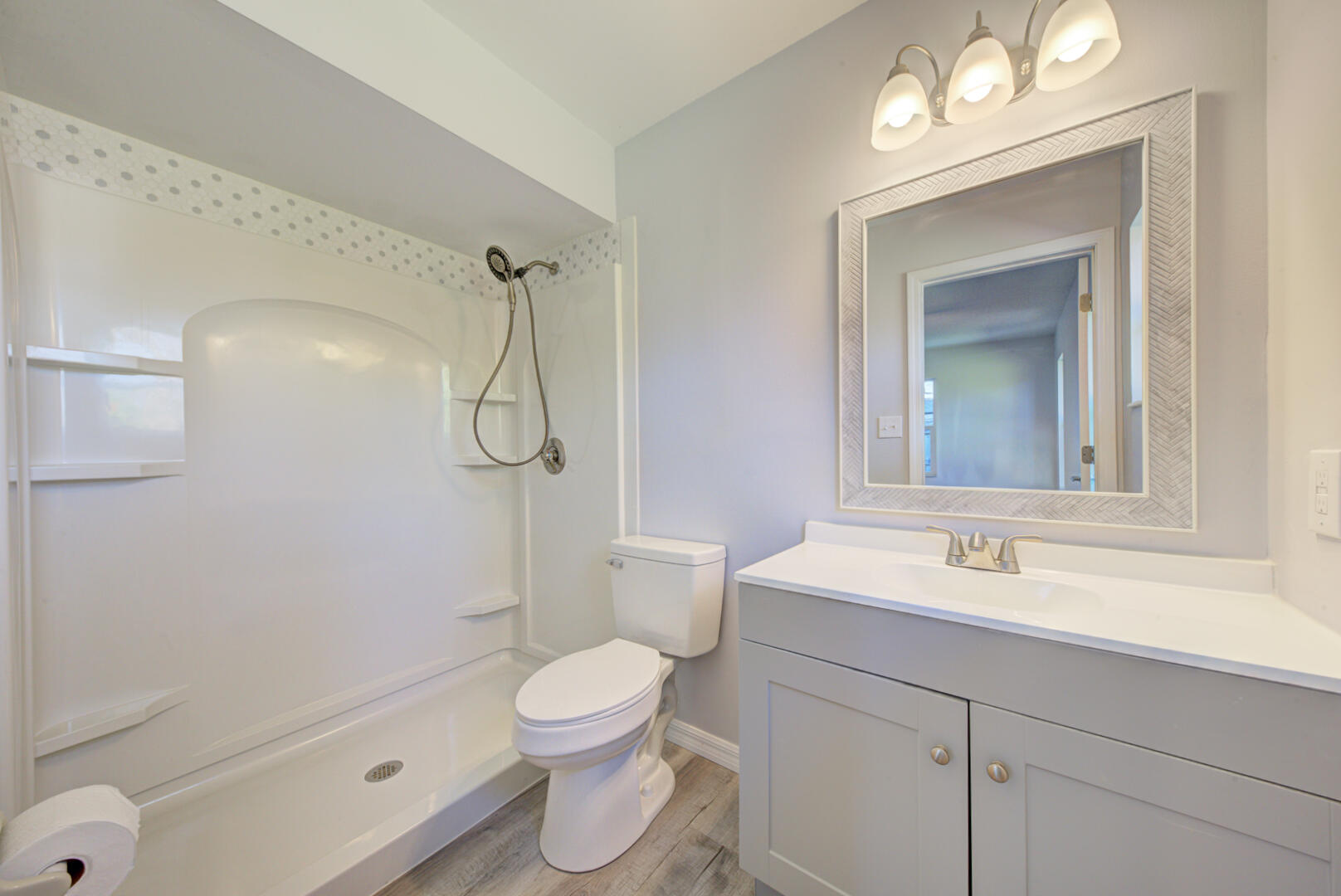 5356 Jamaica Road Cocoa, FL 32927 - Photo 24 of 41 a bathroom with a toilet sink vanity shower and mirror
