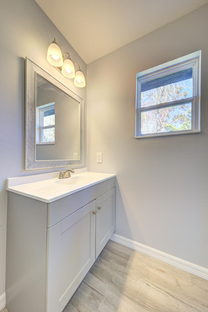 5356 Jamaica Road Cocoa, FL 32927 - Photo 25 of 41 a bathroom with a sink mirror and a window