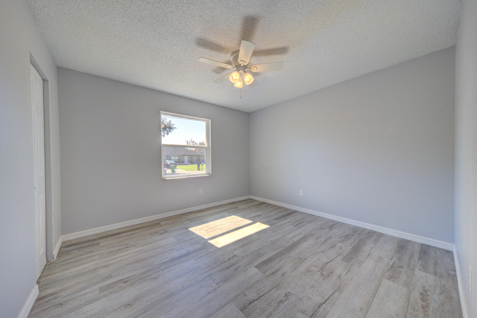 5356 Jamaica Road Cocoa, FL 32927 - Photo 28 of 41 an empty room with wooden floor and windows
