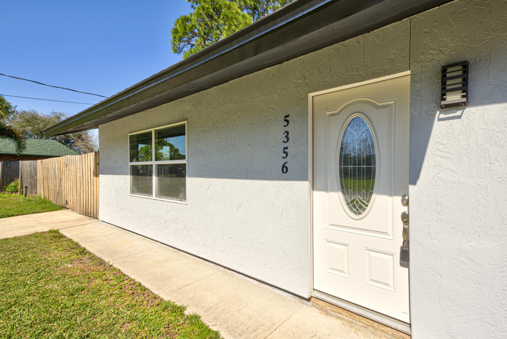 5356 Jamaica Road Cocoa, FL 32927 - Photo 3 of 41 a view of a house with wooden floor and a small yard