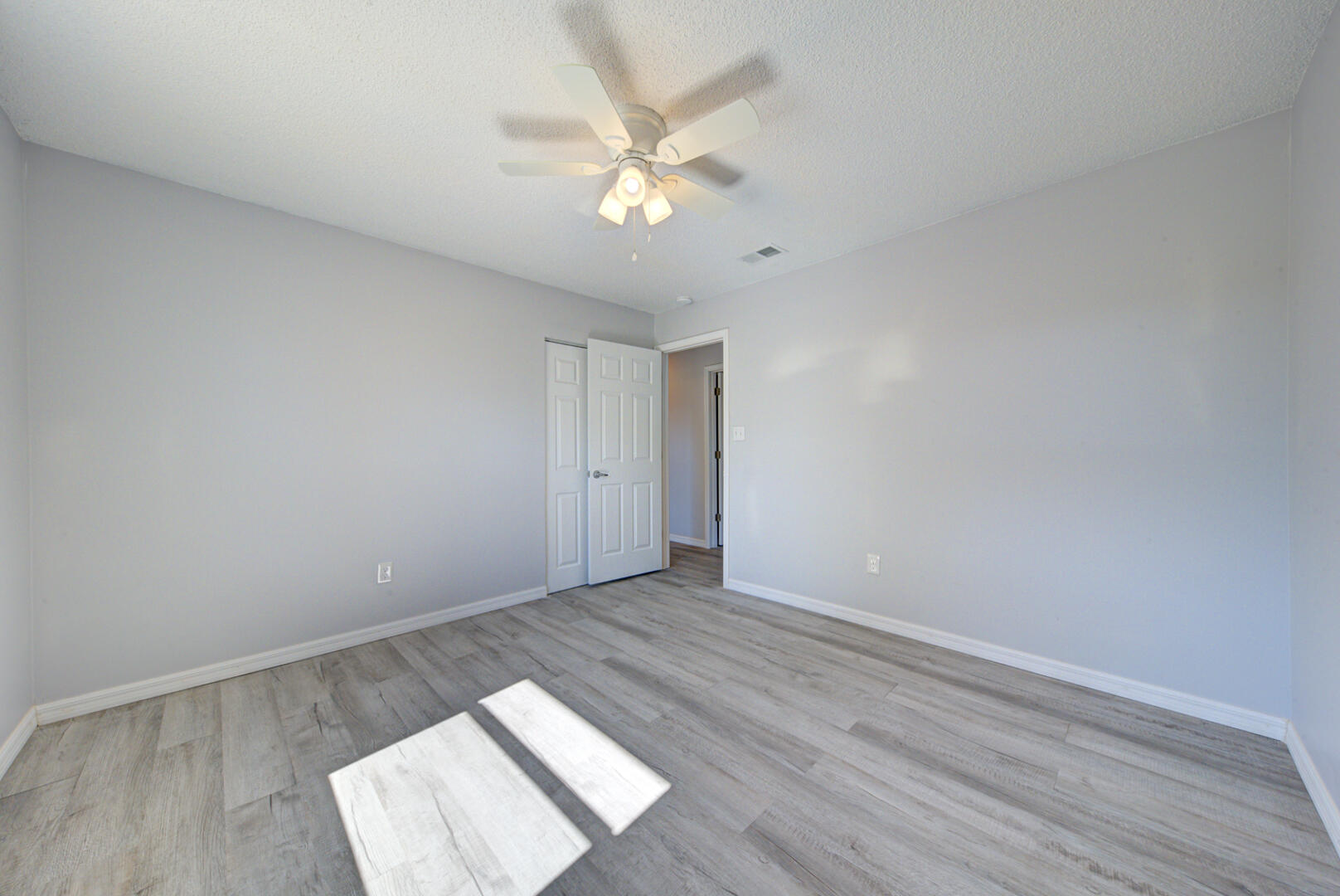5356 Jamaica Road Cocoa, FL 32927 - Photo 31 of 41 an empty room with wooden floor and fan