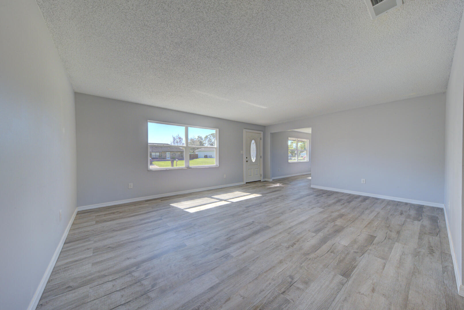 5356 Jamaica Road Cocoa, FL 32927 - Photo 6 of 41 a view of empty room with window and wooden floor