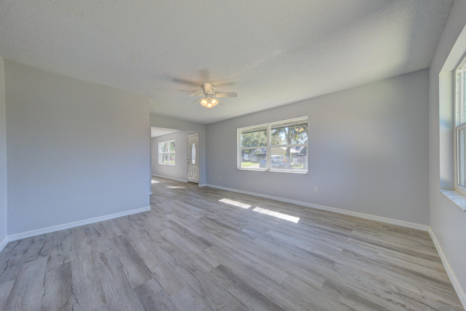 5356 Jamaica Road Cocoa, FL 32927 - Photo 7 of 41 an empty room with wooden floor and windows