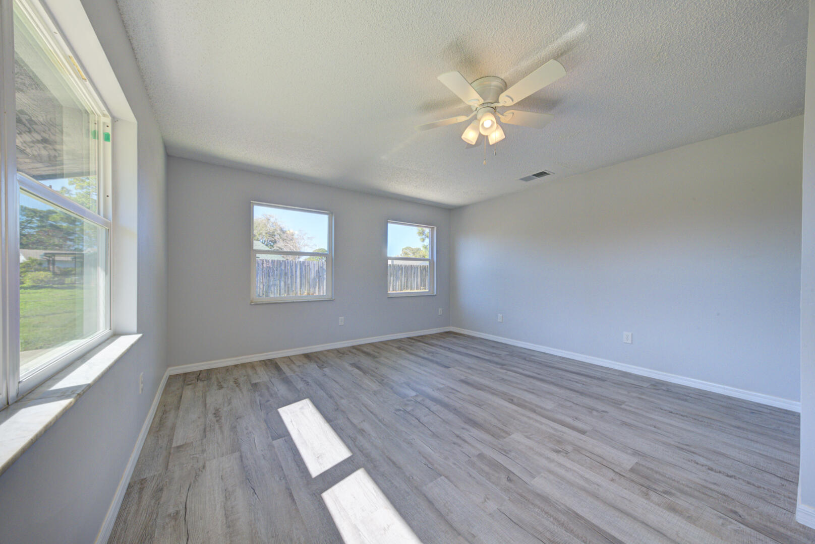5356 Jamaica Road Cocoa, FL 32927 - Photo 8 of 41 wooden floor in an empty room with a window