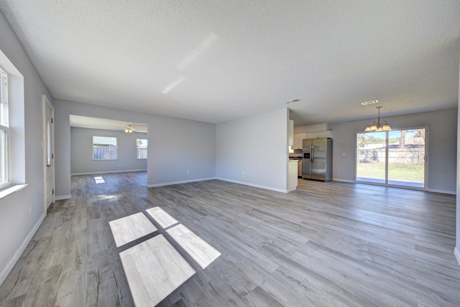 5356 Jamaica Road Cocoa, FL 32927 - Photo 10 of 41 wooden floor in an empty room with a window